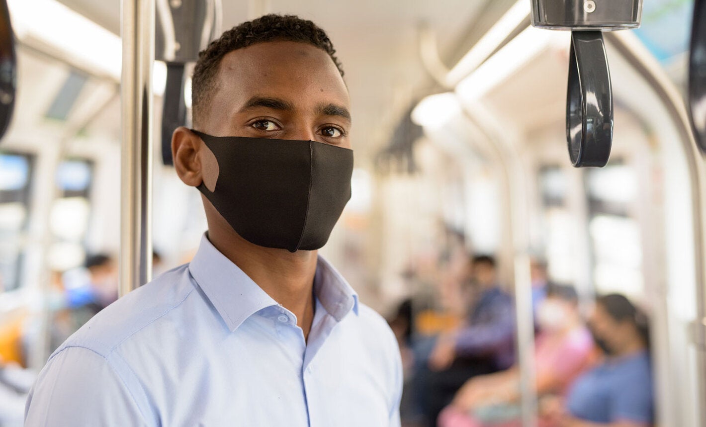 masked man riding bus