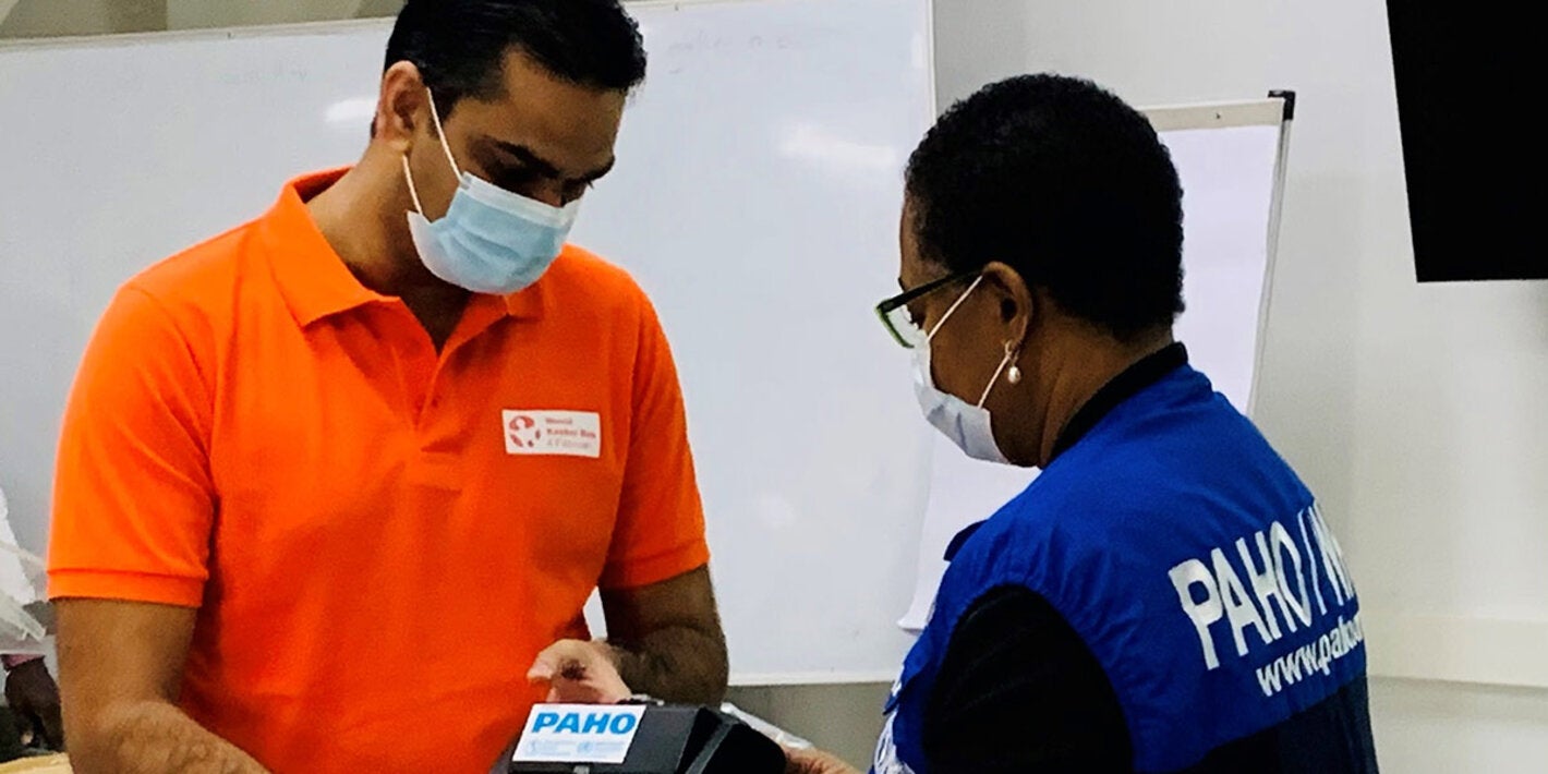 Minister Ramadhin and Dr. Lewis-Bell inspect the biPAP machines at the official handover