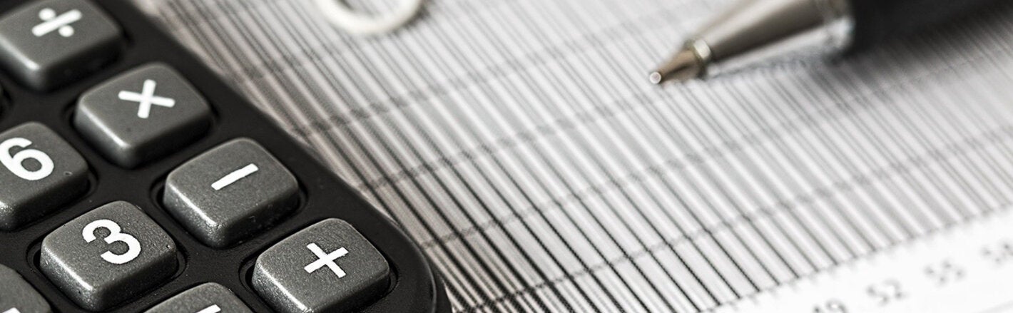 calculator and pen on graph