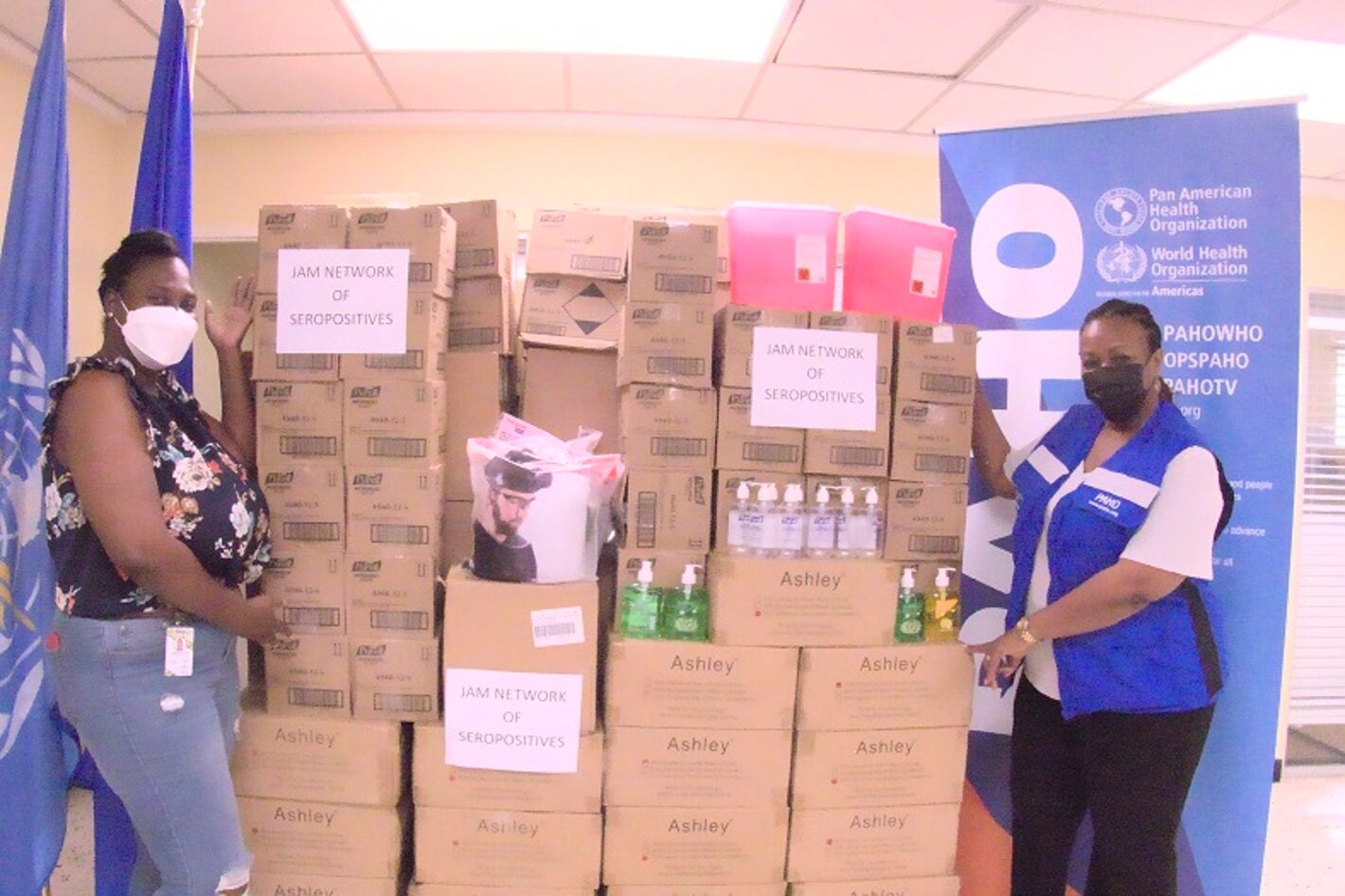 (L-R) Karraine Dillion, Finance Office, Jamaica Network of Seropositives (JN+), pictured in high spirits after receiving personal protective equipment from the Pan American Health Organization (PAHO). Also pictured is Dr. Audrey Morris, Acting Pan American Health Organization/World Health Organization Representative for Jamaica, Bermuda and the Cayman Islands.  