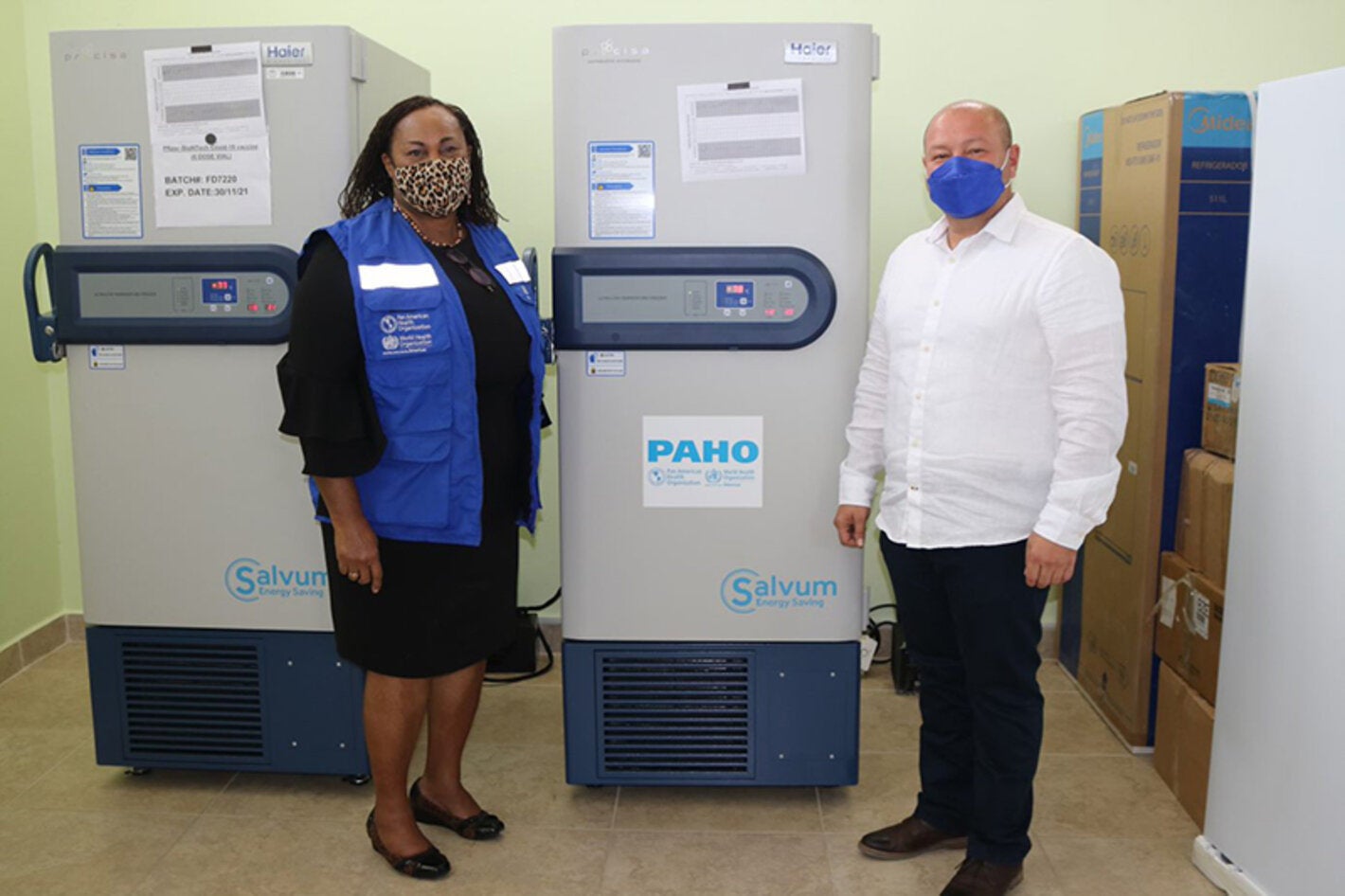 Photo of PWR and Minister of Health flanking the ULT Freezer