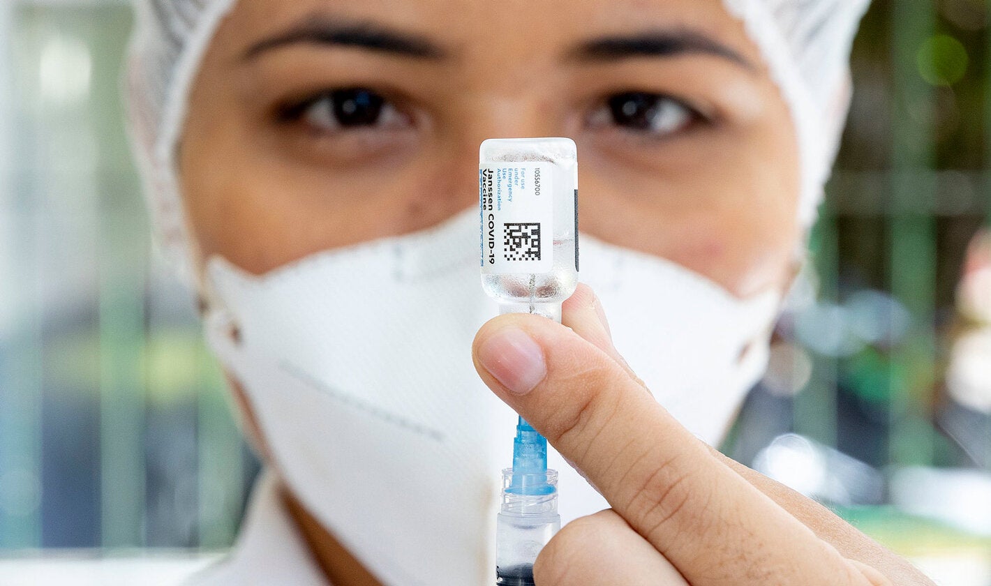 Health worker with COVID-19 vaccine in hand