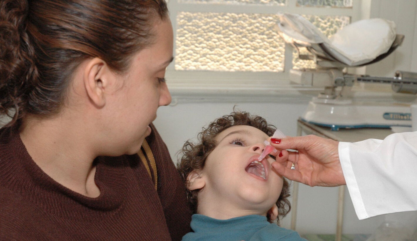 Boy receives oral polio vaccine