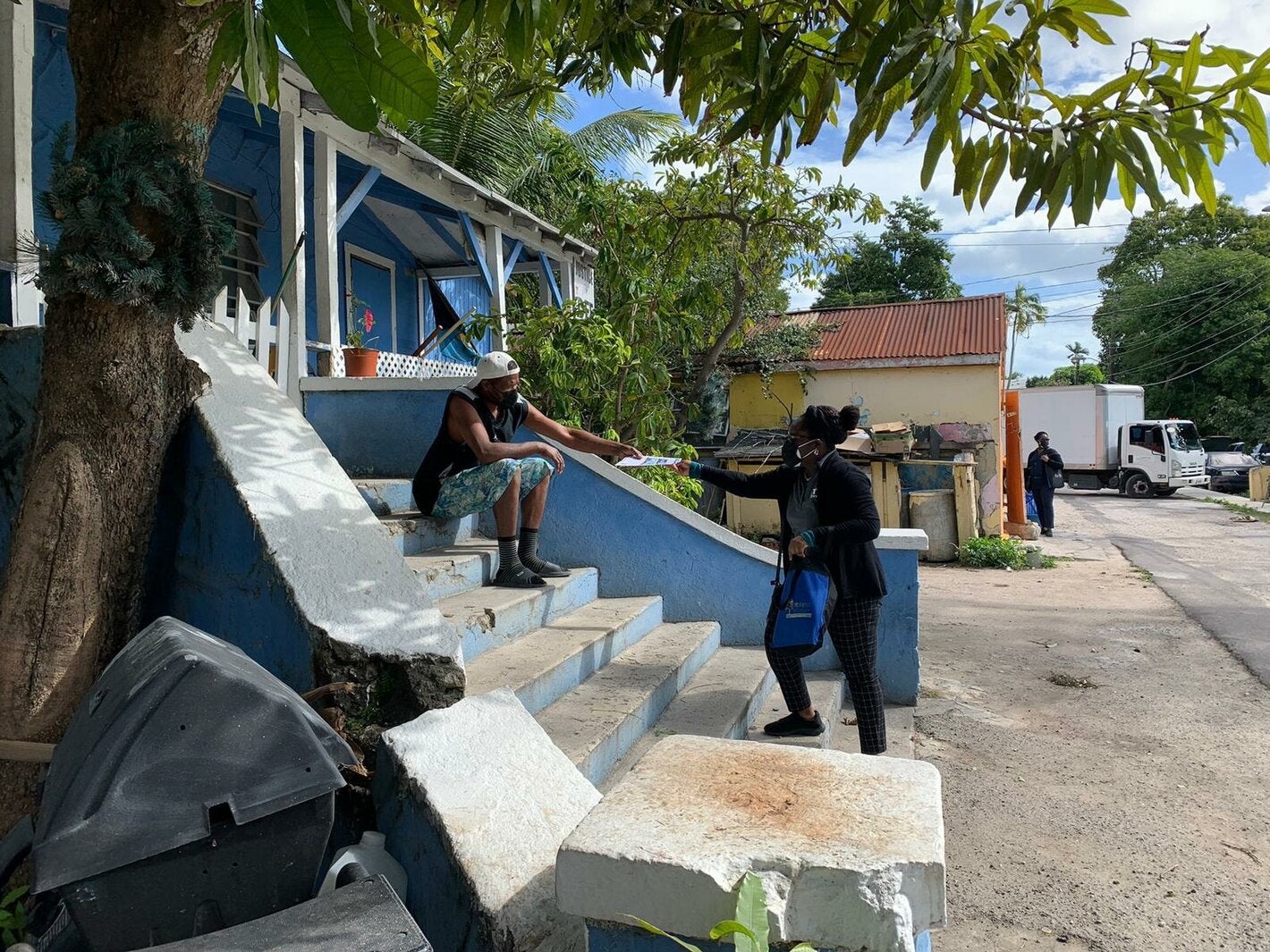 Healthcare worker sharing a vaccine pop-up flyer to a resident.