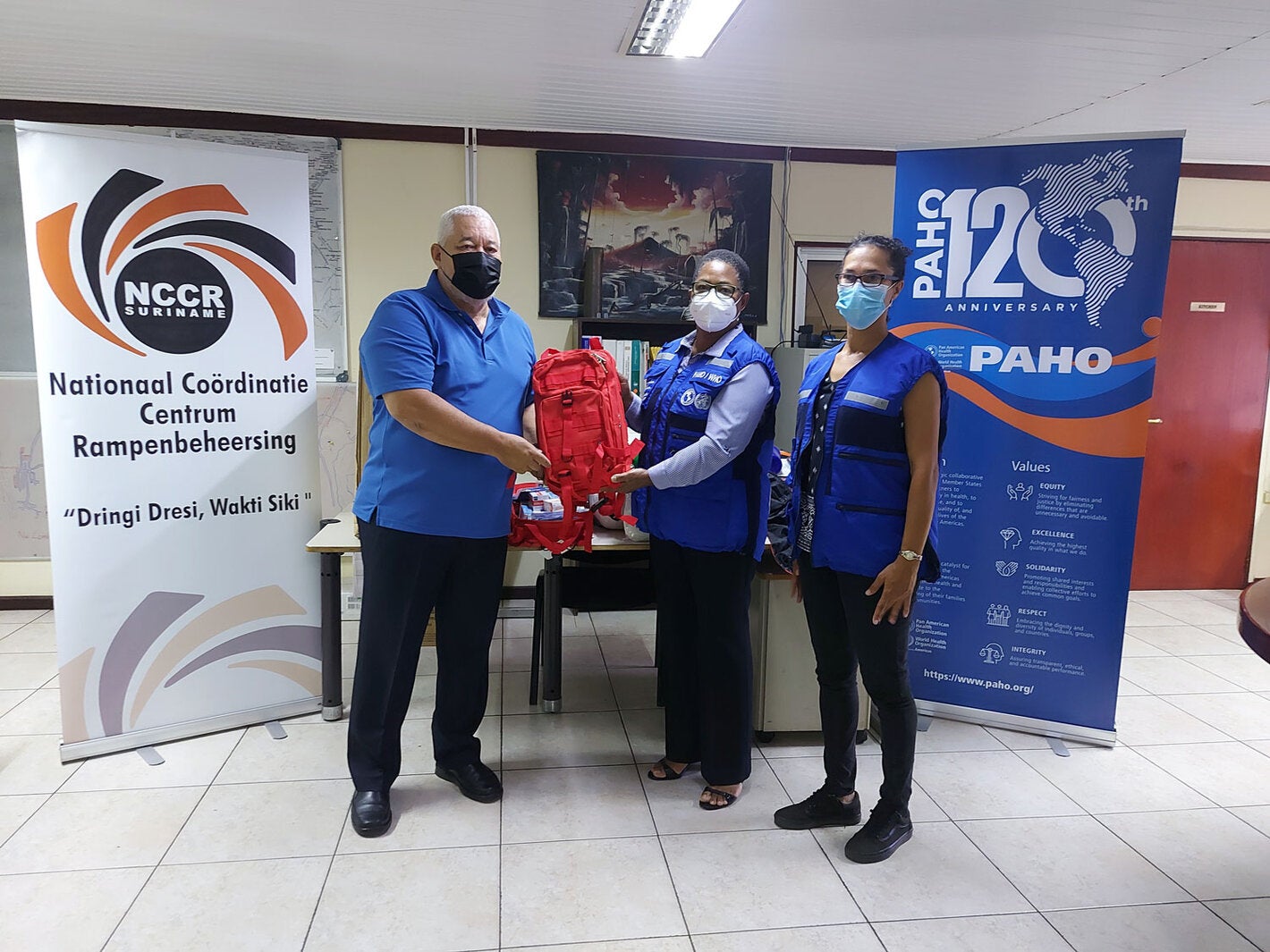 NCCR Coordinator Lt. Col Jerry Slijngard, PAHO Representative Dr. Karen Lewis-Bell, and PAHO National Consultant Astrid van Sauers