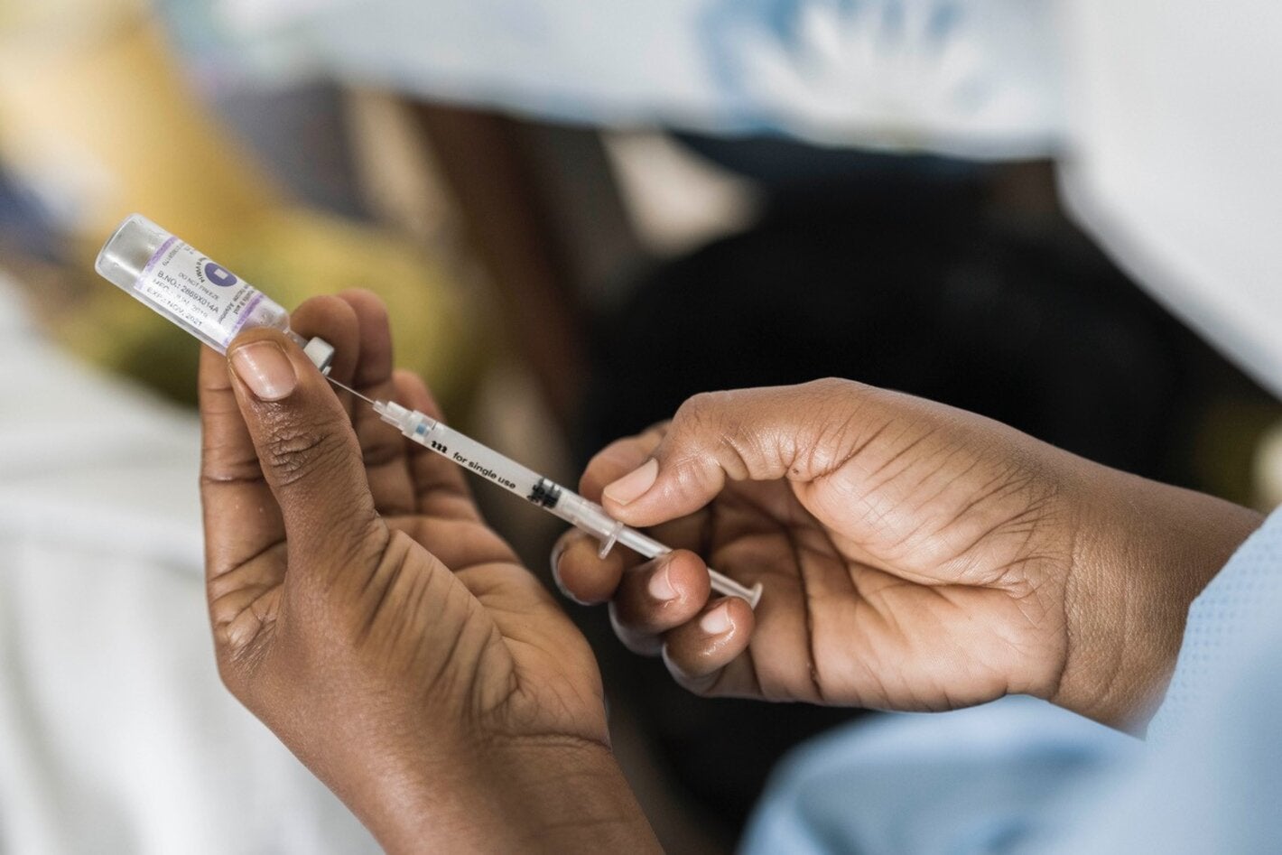 Health workers holds COVID-19 vaccine