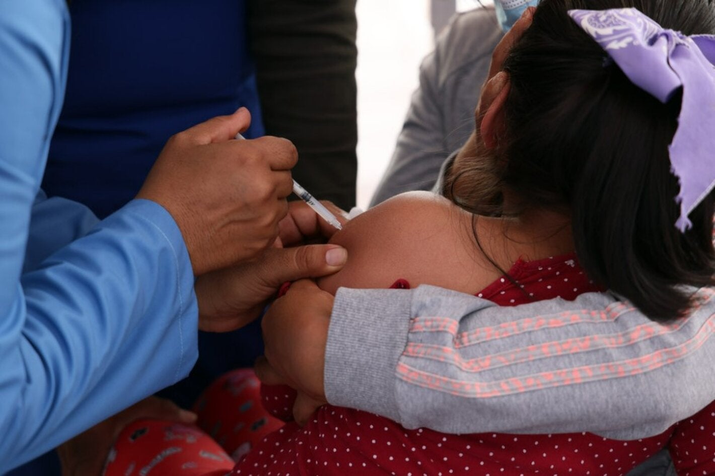 A girl receives a vaccine