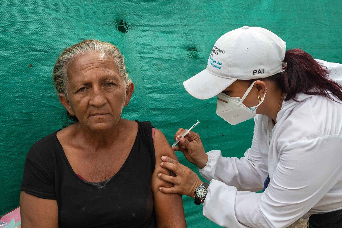 Older adult receives vaccine.