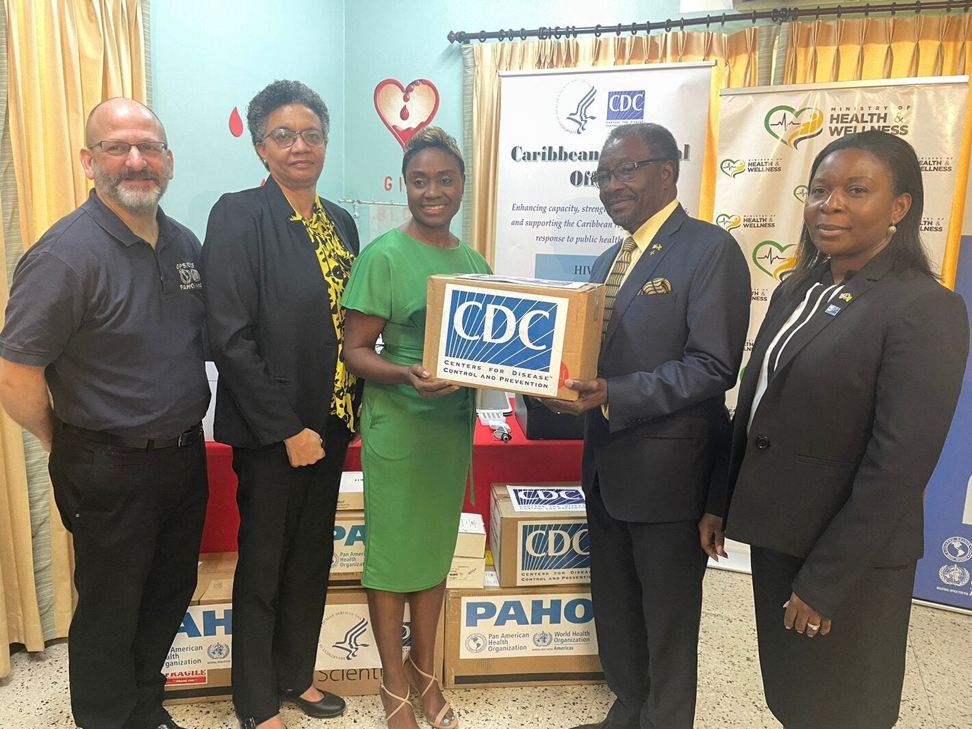 U.S. Ambassador Nick Perry (2nd right) pictured with Hon. Julieth Cuthbert-Flynn, Minister of State, Ministry of Health and Wellness (3rd left) while (L-R) Mr. Ian Stein, Pan American Health Organization/ World Health Organization Representative to Jamaica, Dr. Marlene Tapper, Director of the National Laboratory Services and Dr. Emily Kainne Dokubo, Country Director, U.S. Centres for Disease Control & Prevention look on. 