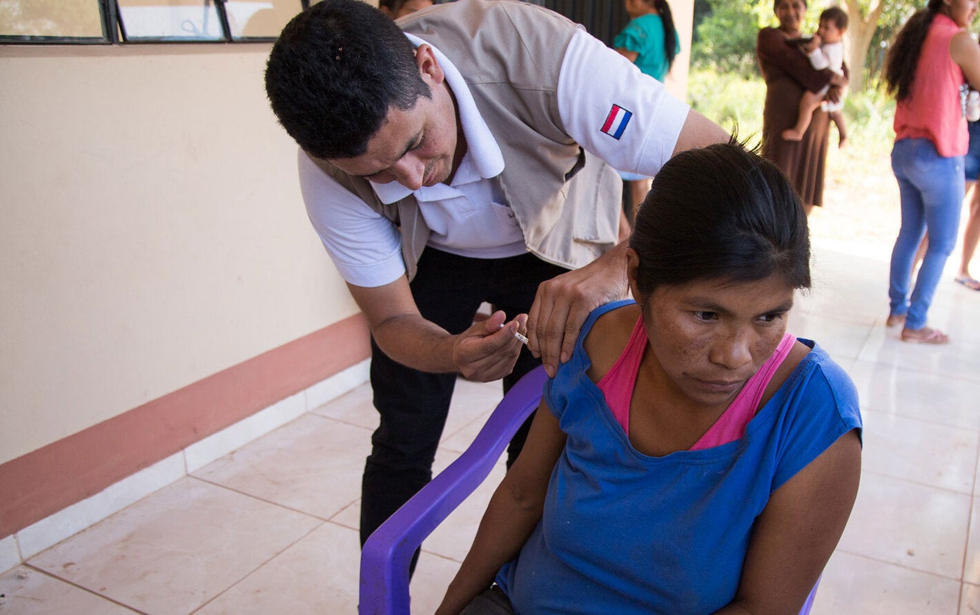 Woman receives vaccination in a remote location