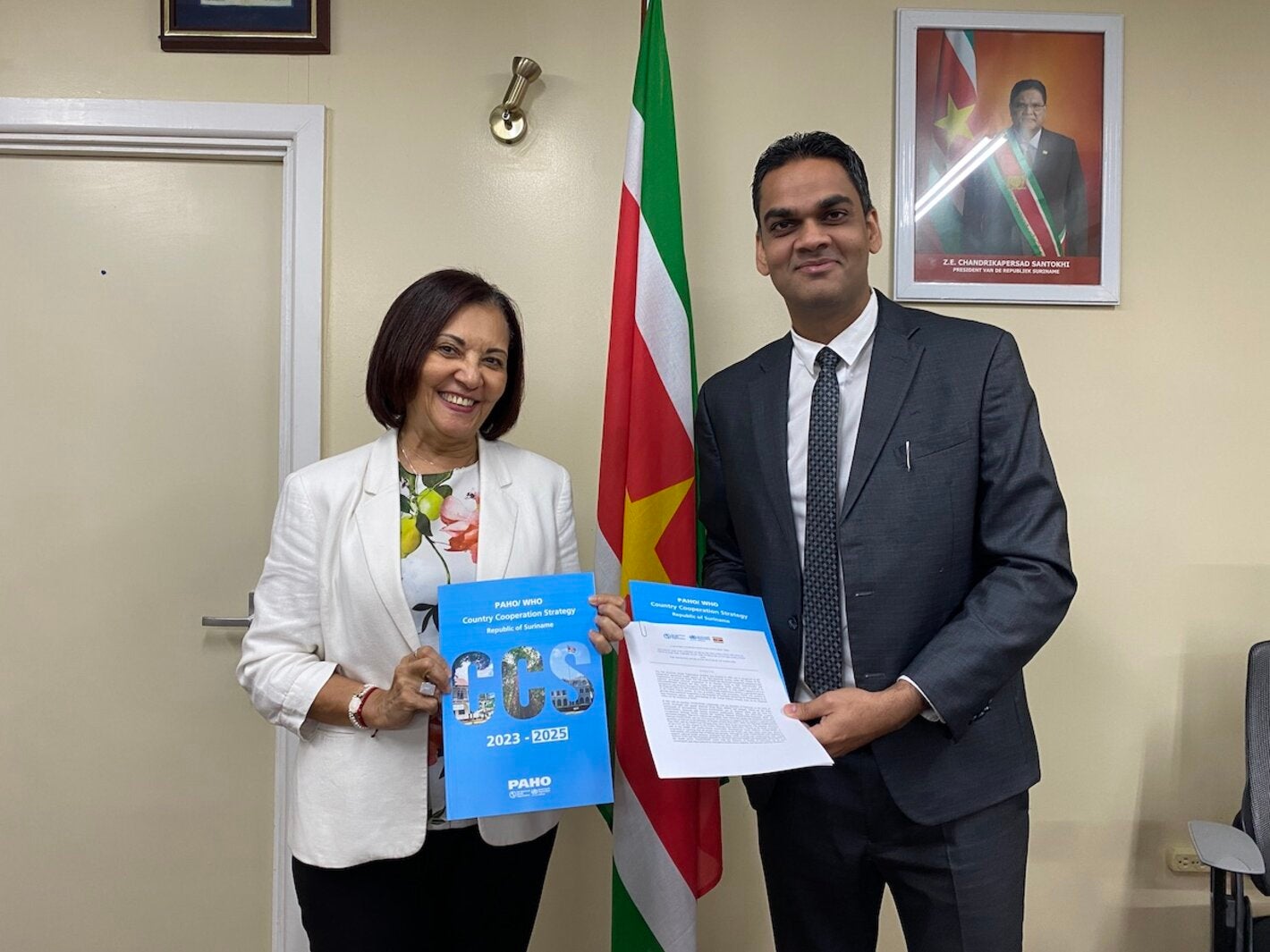 PAHO/WHO Representative Suriname Dr. Lilian Reneau-Vernon & Minister of Health Dr. Amar Ramadhin during the signing