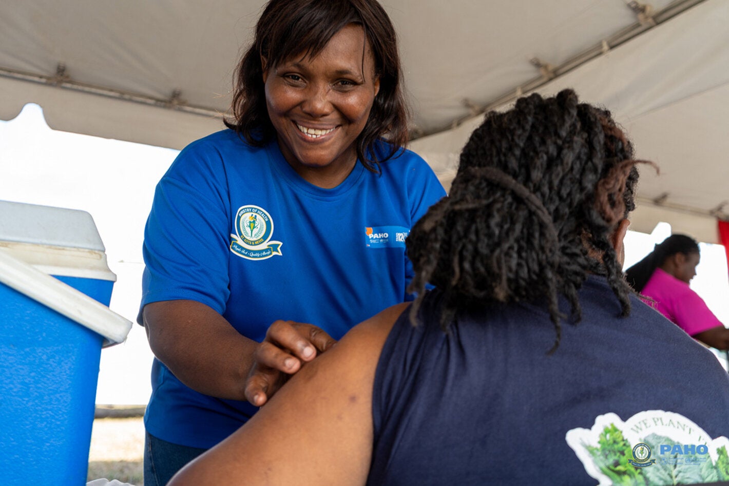 A nurse prepares to vaccinate an adult