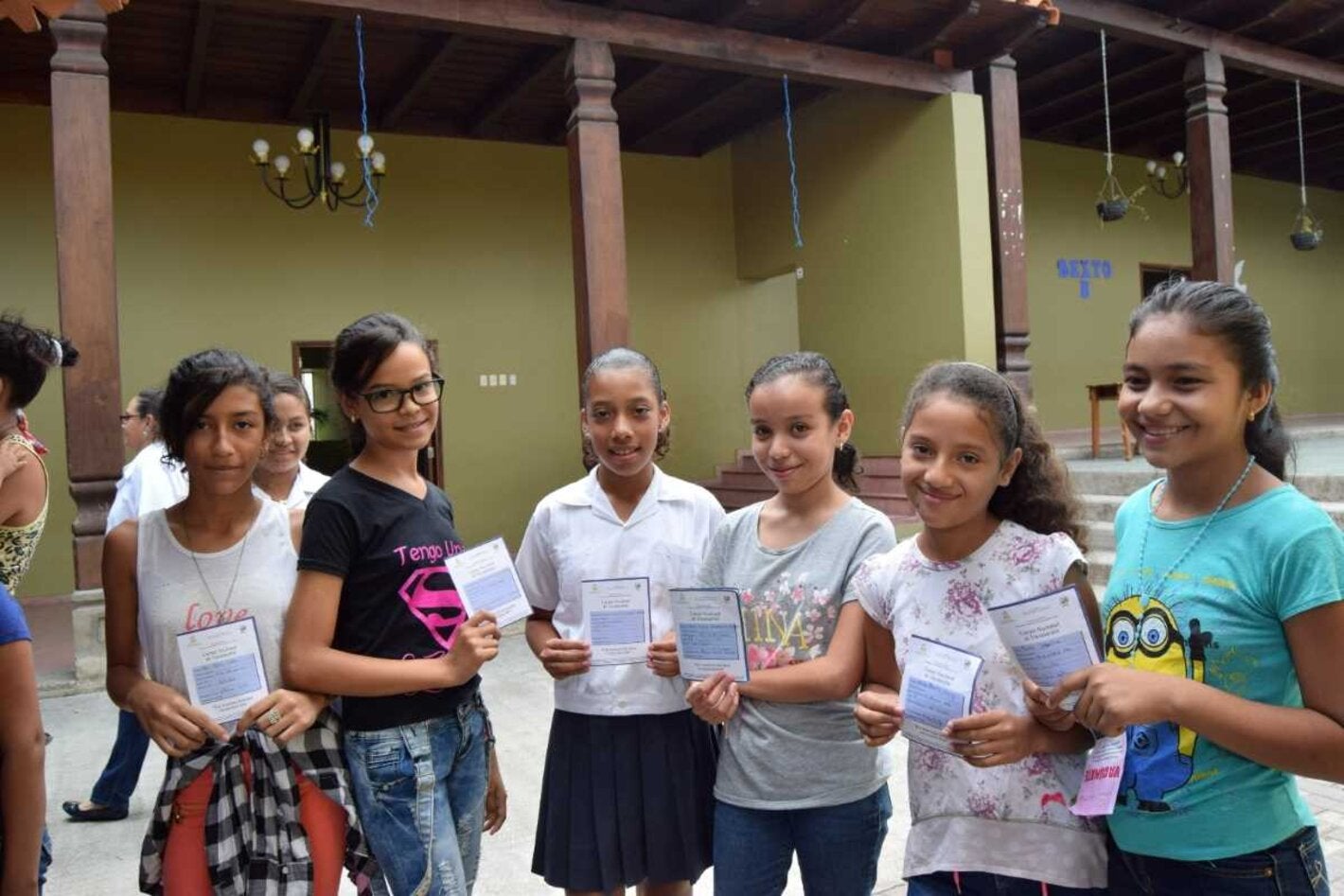 Niñas mostrando carnet de vacunación VPH