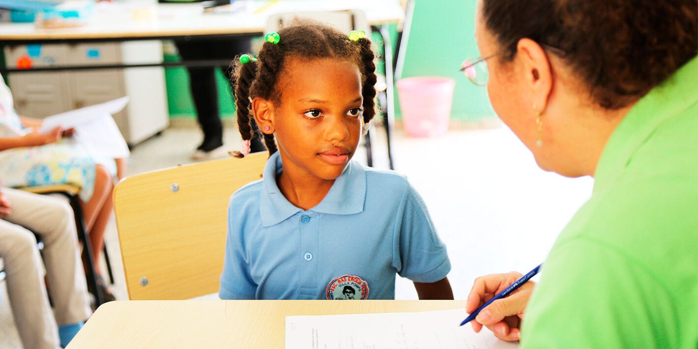 Girl and health worker in a school in Dominican Republic