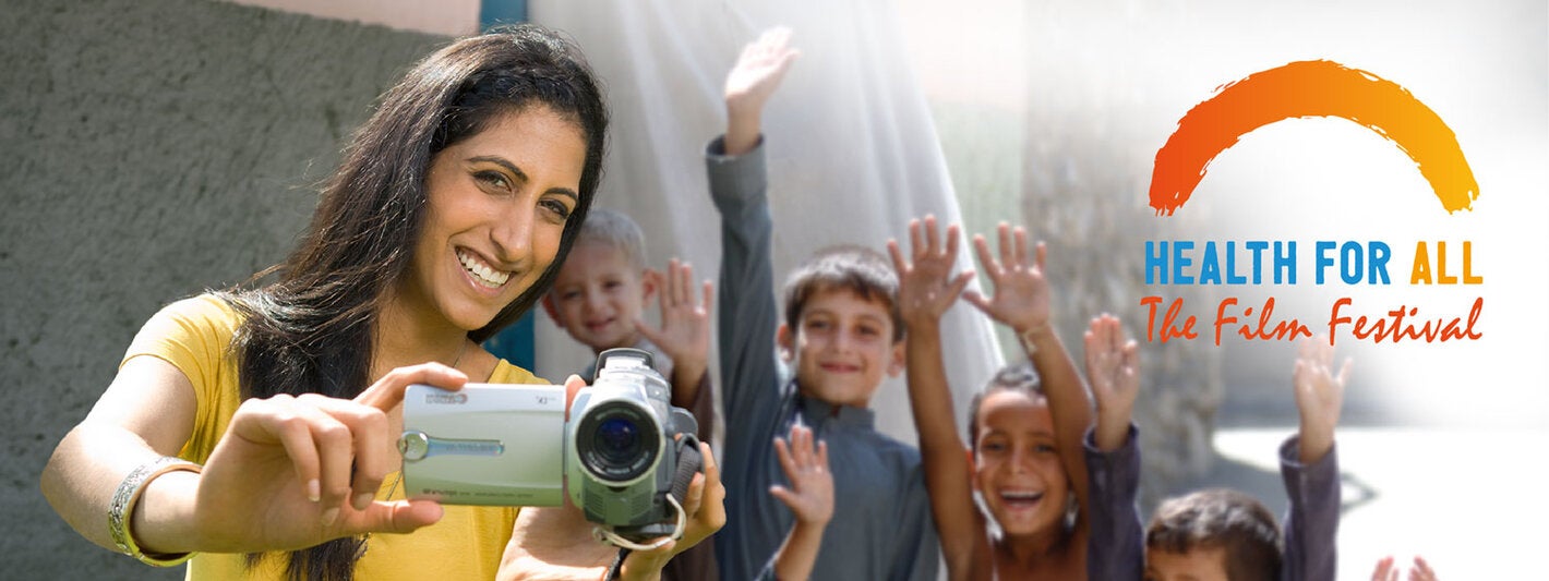 Woman with camera and children behind her