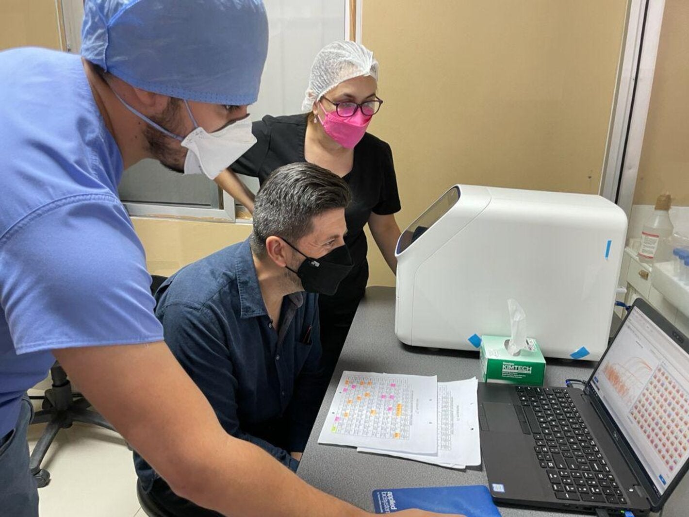 jairo mendez being shown data on a laptop