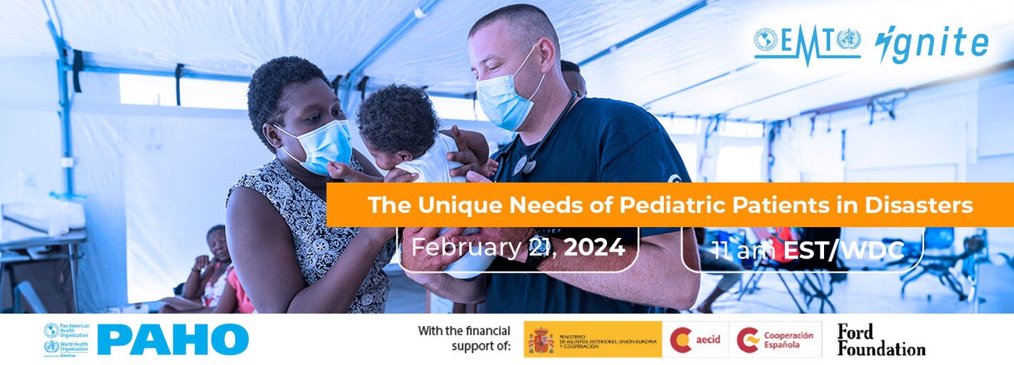 A mother and a frist responder holds a baby inside a hospital