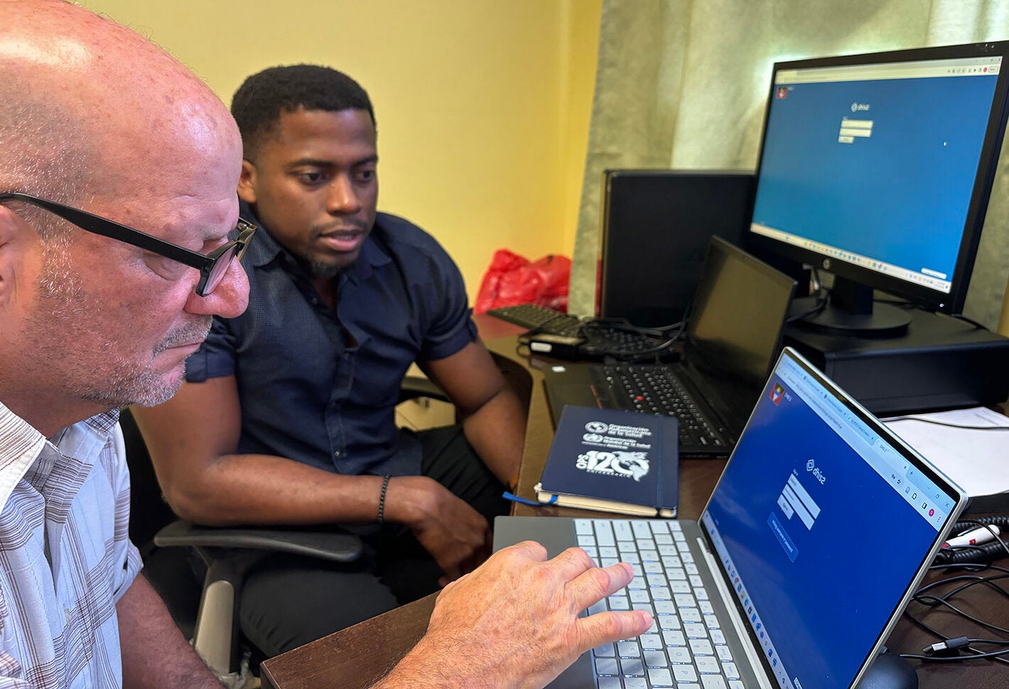 Two men looking at computer