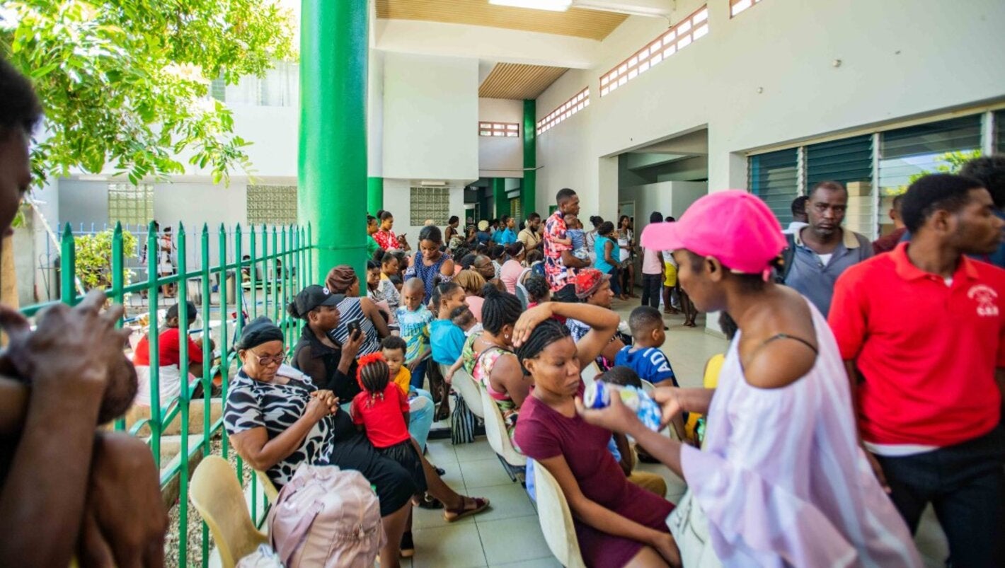 A crowd gathers at the gates of the HUP waiting for health care