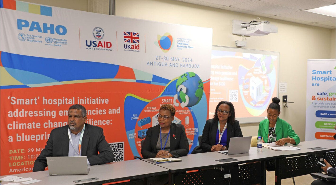 2 women, emergency medical team members, checking their supplies inside the movil hospital