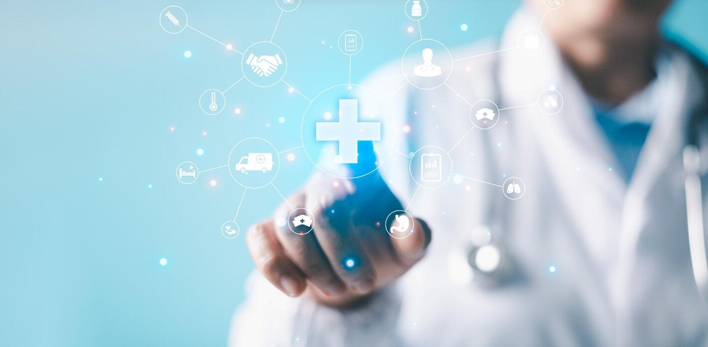 burred photo of the body of a health provider pointing at icons representing health