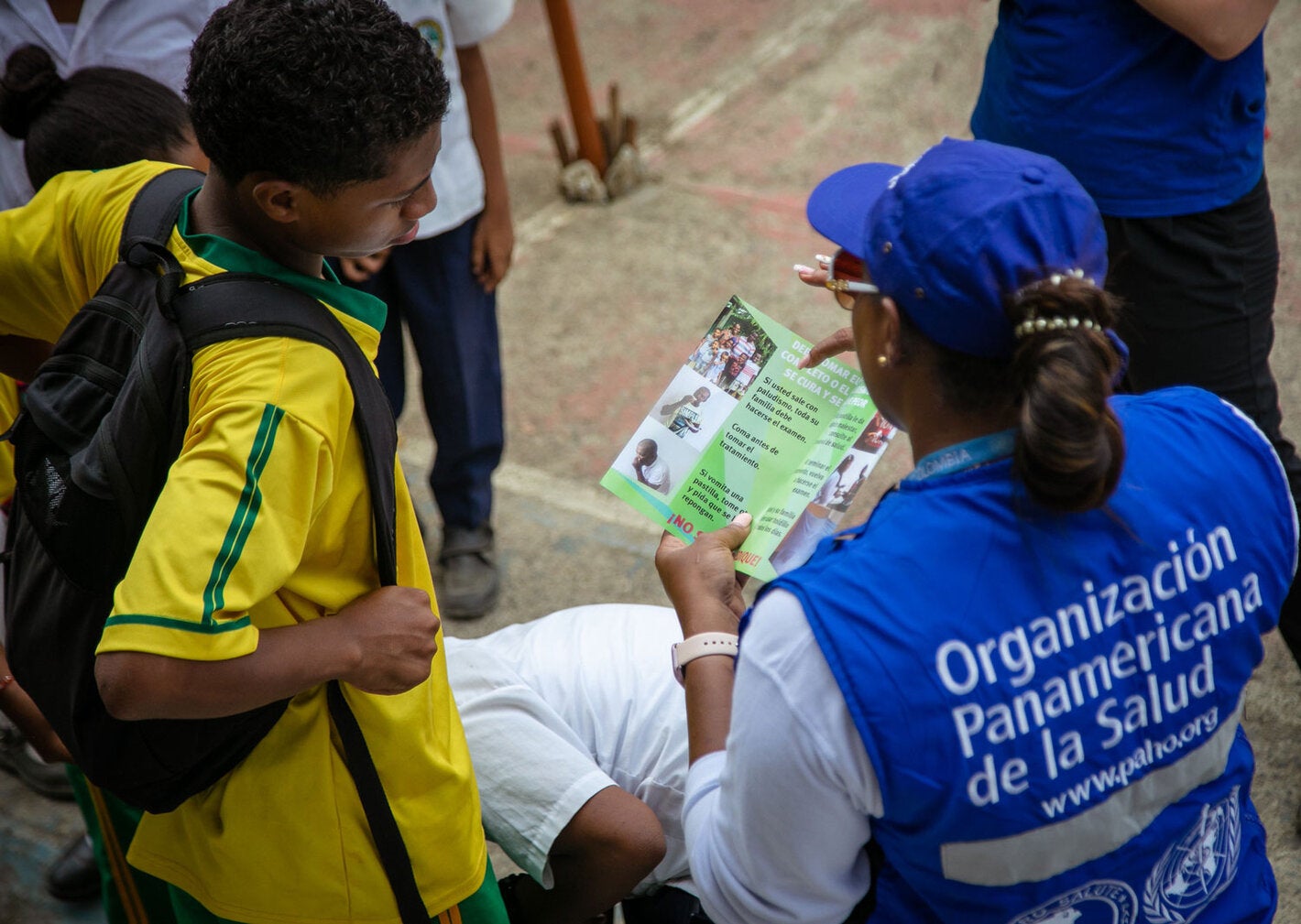 A PAHO female staff has been deployed to rural area. She is sharing health information with an adolescent.