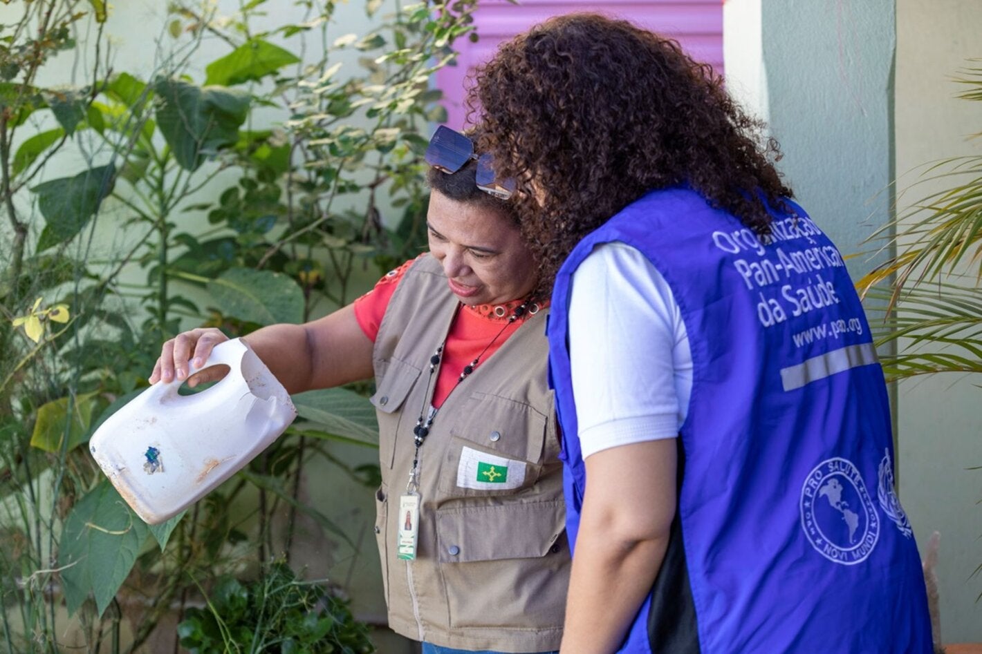 In Brazil, community health workers visit local residents to help find and destroy mosquito breeding sites.