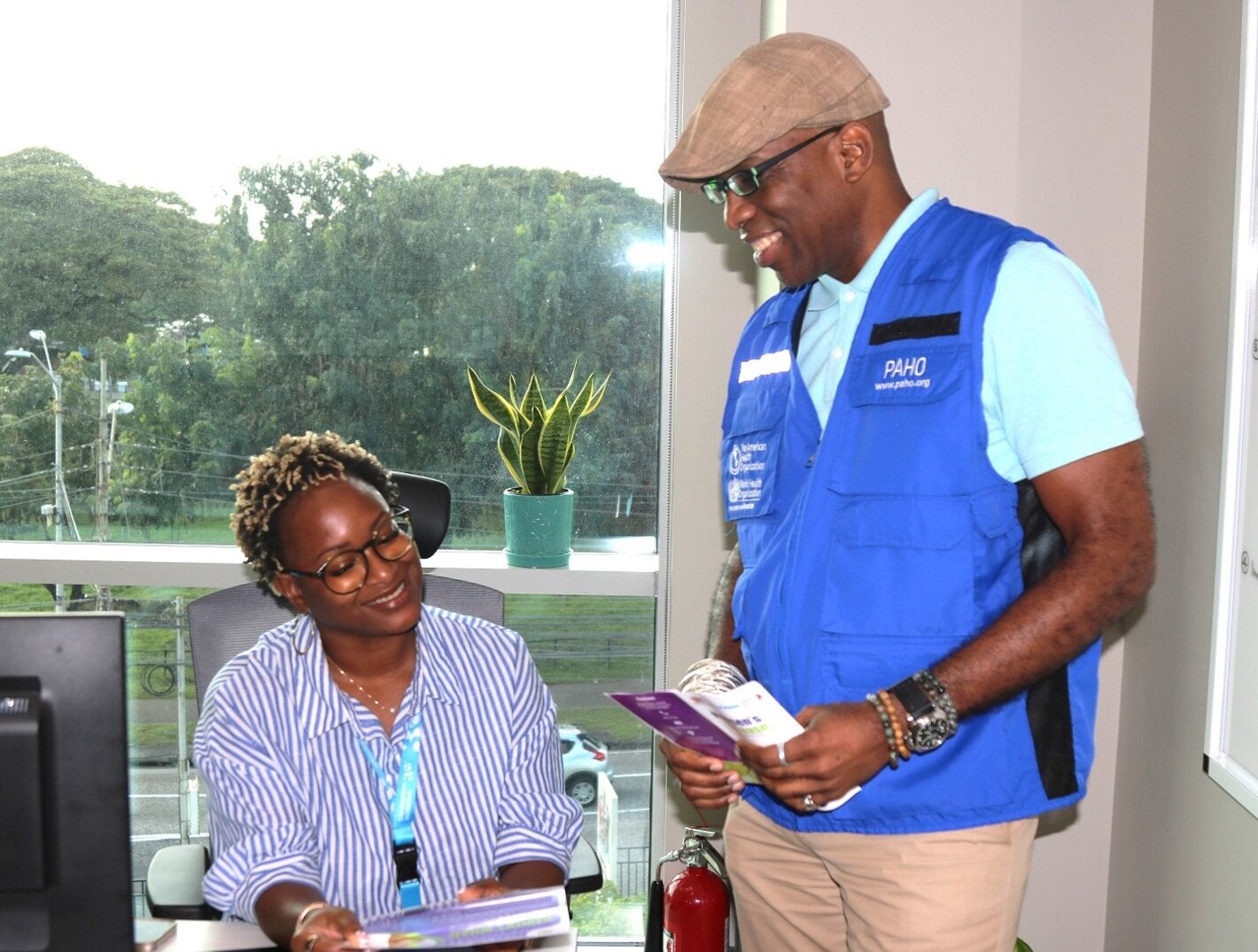 L-R (seated) Dr Ayanna Alexander , Technical Officer - Health Promotion, Life Course, and Determinants and (standing) Dr Stephen Nurse-Findlay, Advisor, Communicable Disease Control and Elimination review the printed Hansen’s disease communication materials.