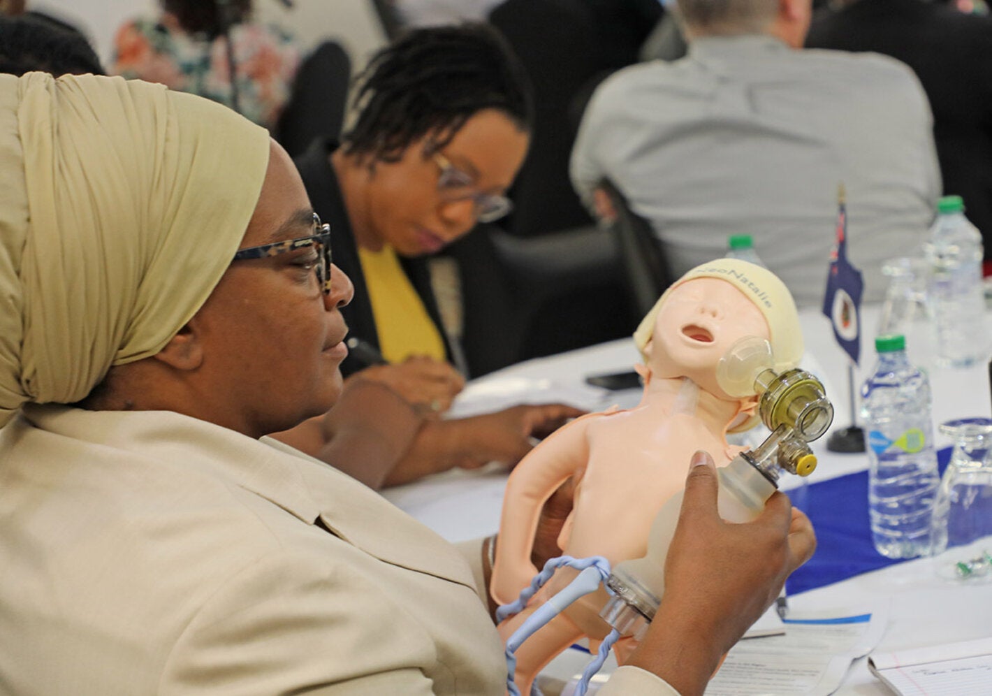 Conference participant looking at model of a baby