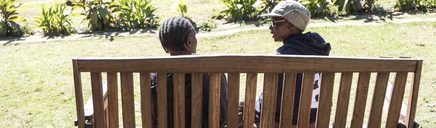 people seated in a bench talking