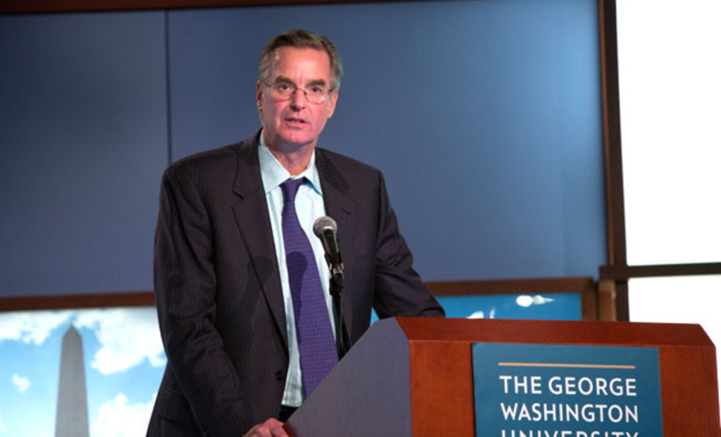 Dr. Anderson speaks behind a podium at GWU