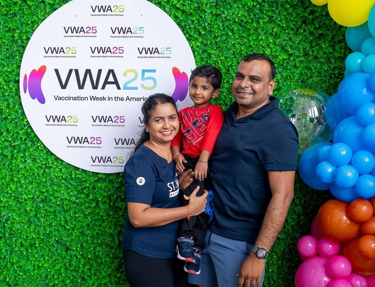 A happy family at the Vaccination and Health Fair for VWA25