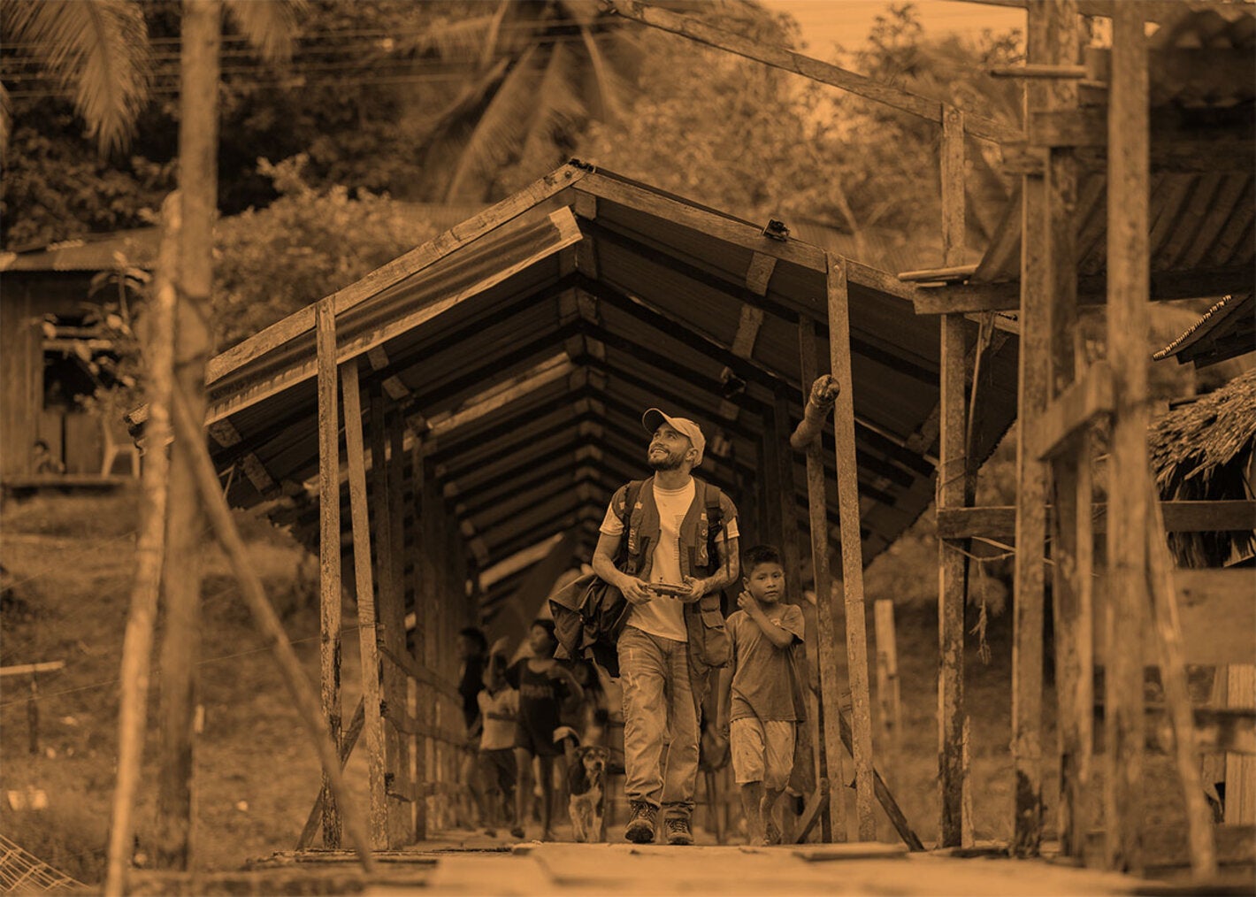 stylized image man and boys on a field trip cross a bridge