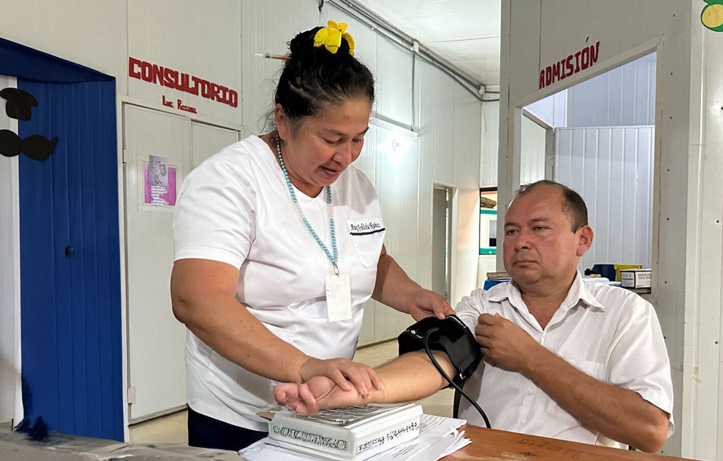 Patient at health centerchecks his blood pressure