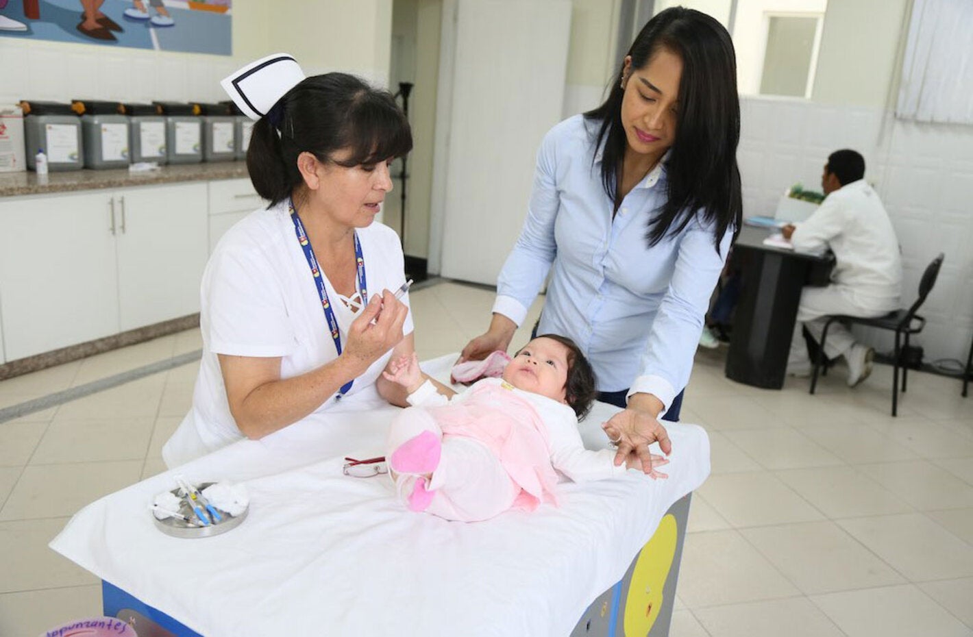 Enfermera vacuna a bebé