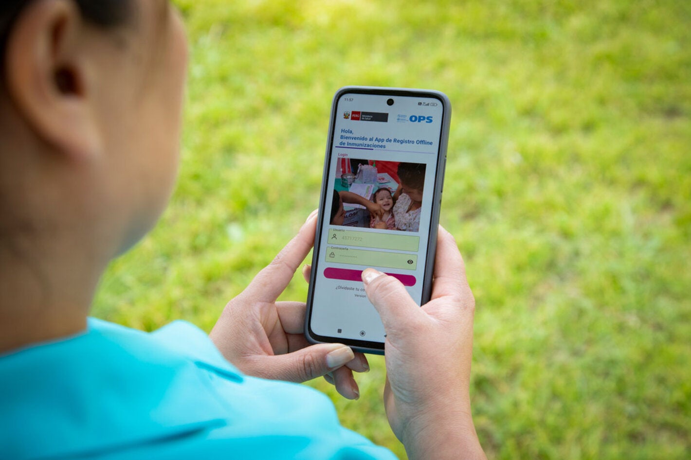 Person holding a mobile phone with immunization's application