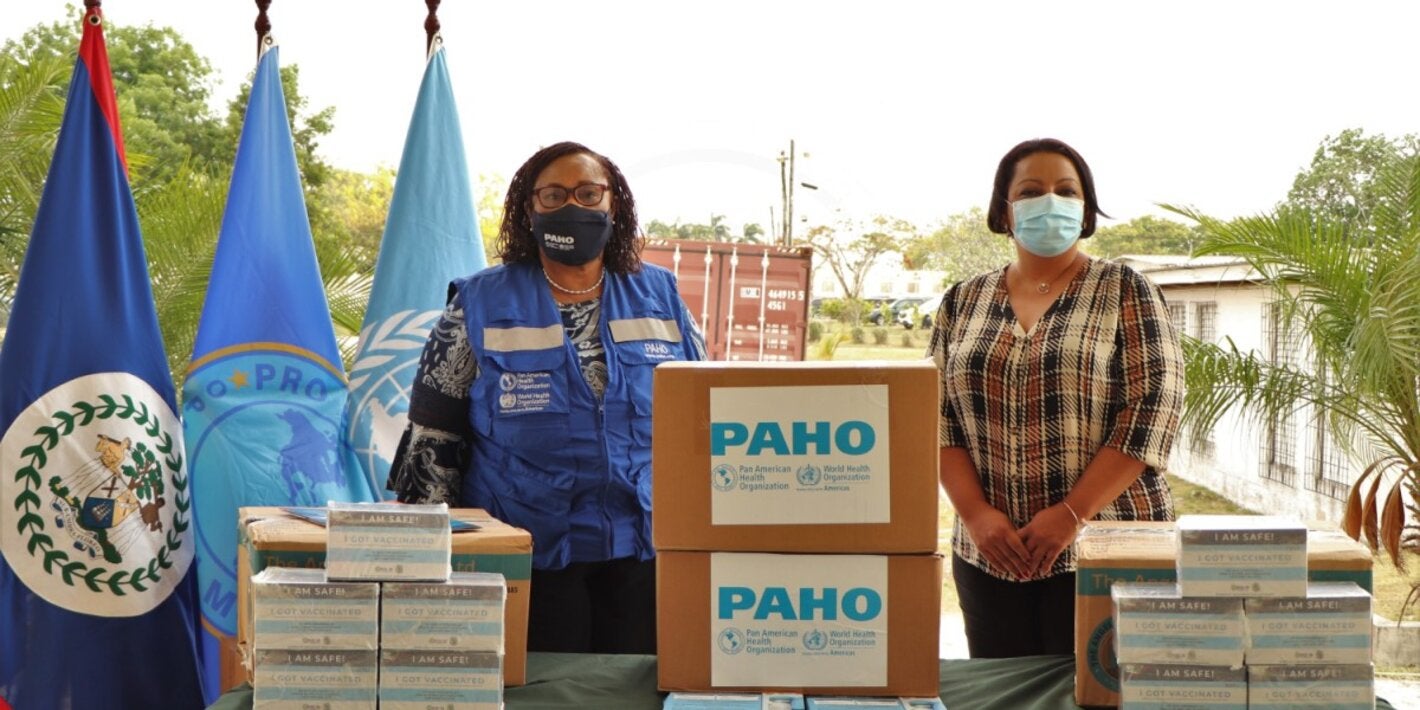 Chief Executive Officer of the Ministry of Health and Wellness Belize, Dr. Deysi Mendez, accepting donated items from PAHO/WHO Representative of Belize, Dr. Noreen Jack.