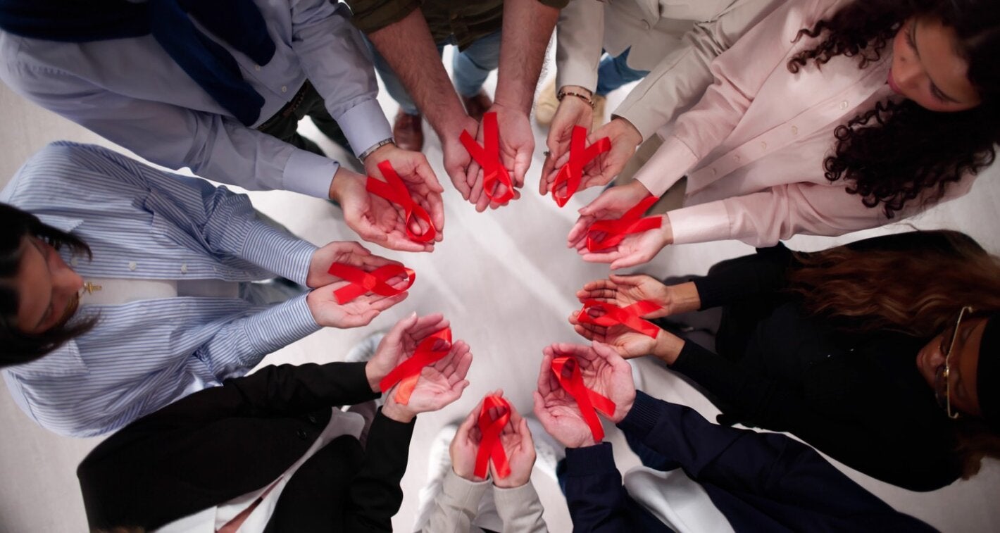 in a circle holding ribbons