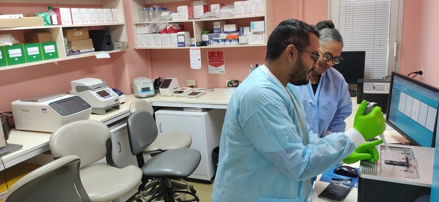 A lab technician and Professor Christine Carrington, Professor of Molecular Genetics and Virology in the lab at the UWI.