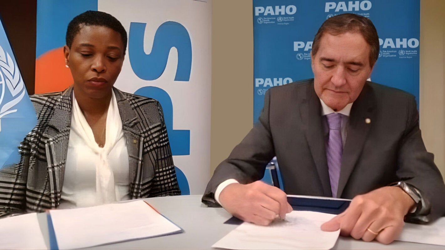 Photo Caption: (L-R) Dr. Rhonda Sealey-Thomas Assistant Director of the Pan American Health Organization witnesses the signing of the Framework Agreement by Dr. Jarbas Barbosa, PAHO Director