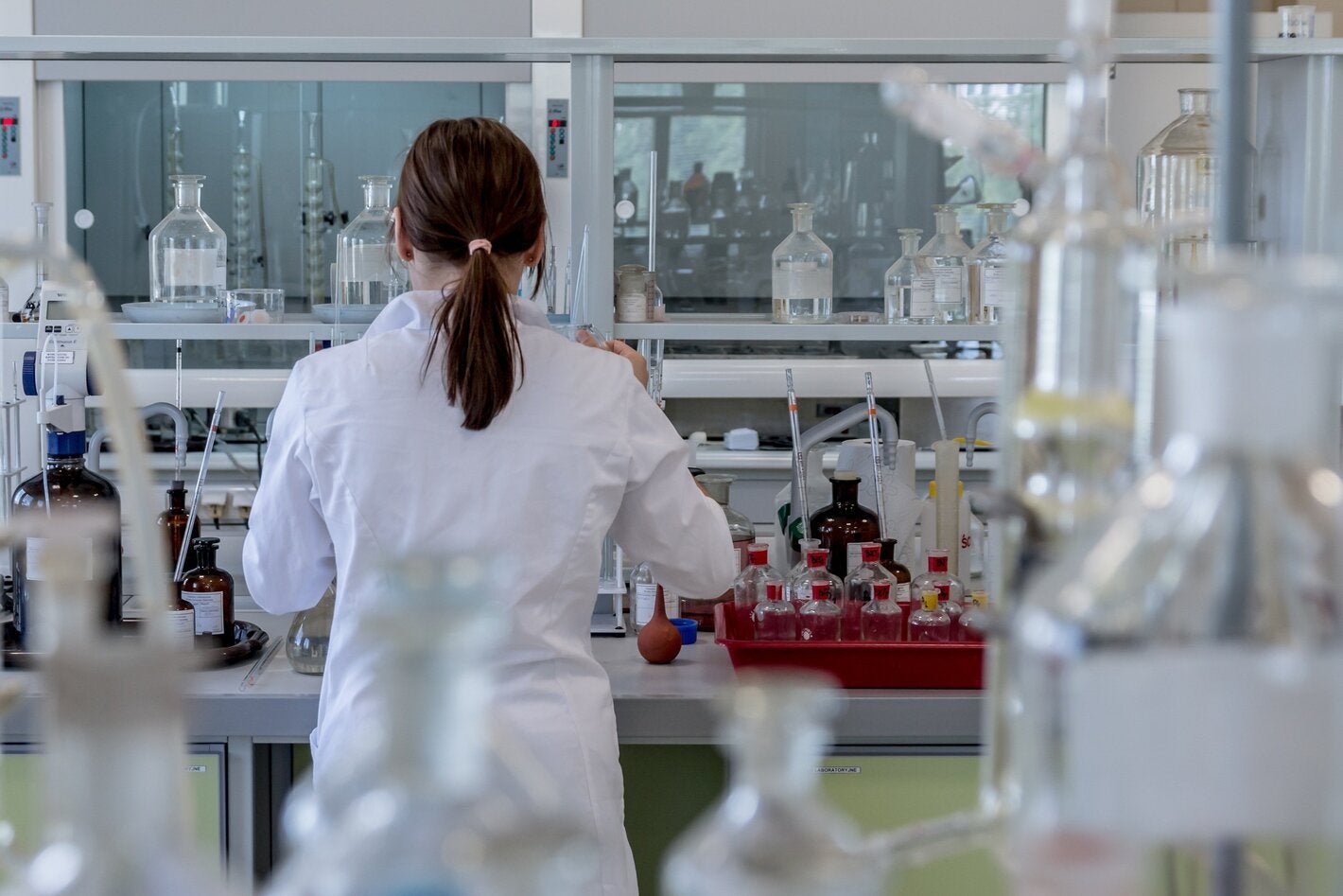 Woman backing camera in laboratory.