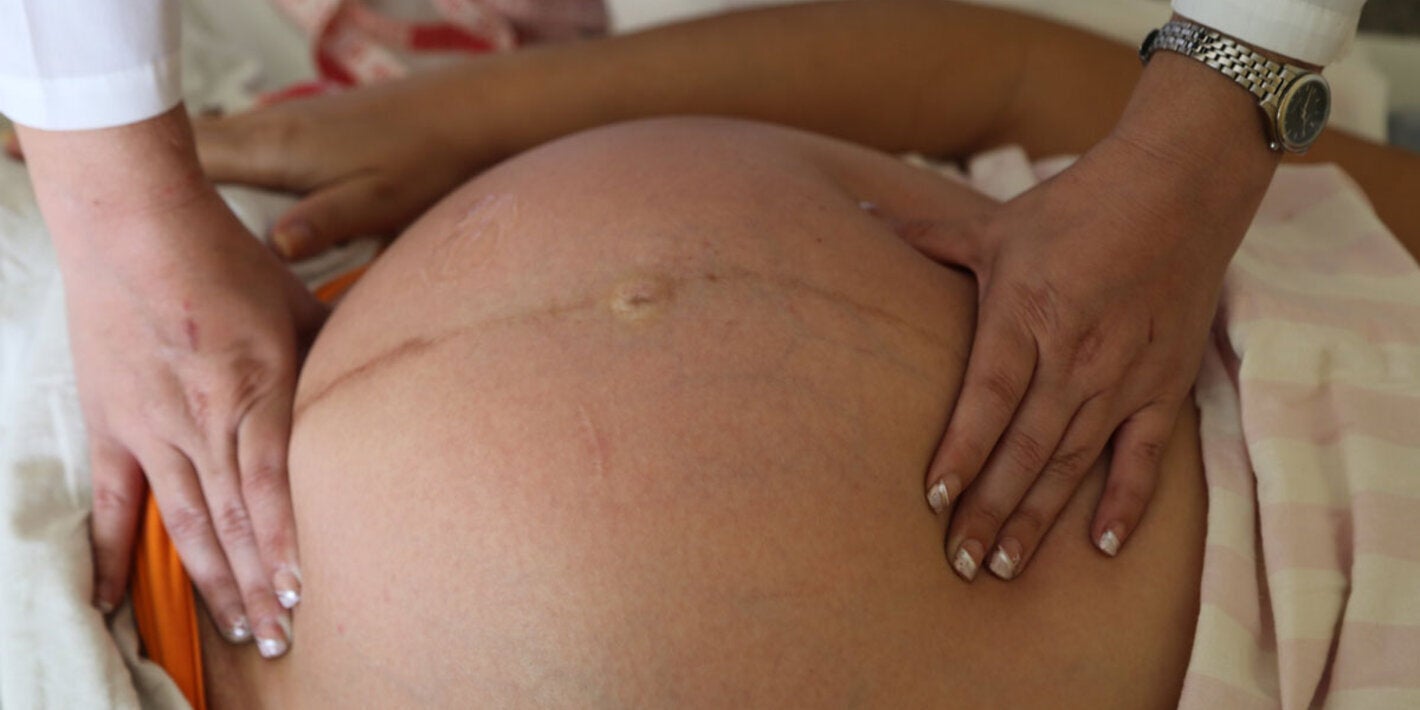 pregnant women receiving a physical examination