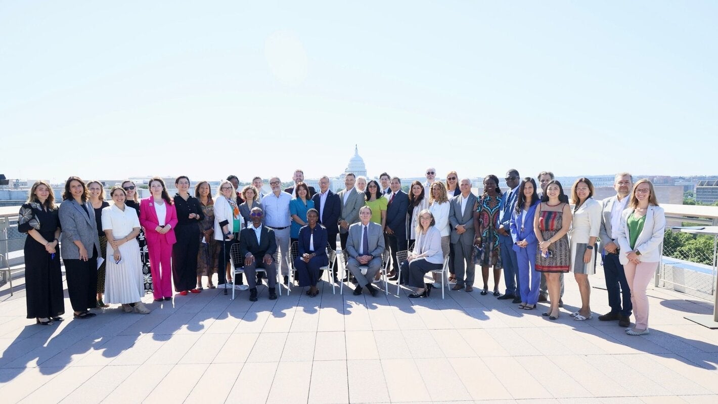 attendees from the meeting standing at a terrace