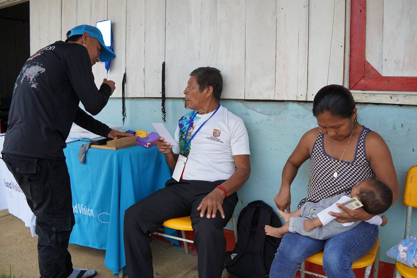 Health worker and community members participate in a health care and health promotion activity