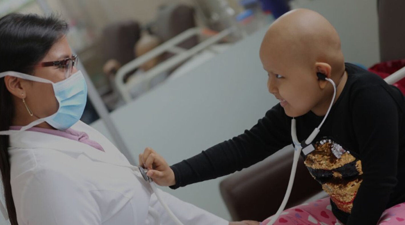 child with cancer interacting with doctor