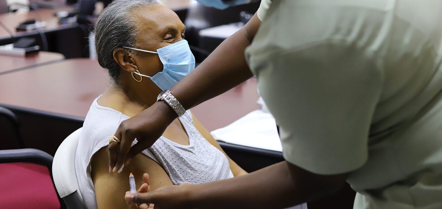 elderly woman being vaccinated