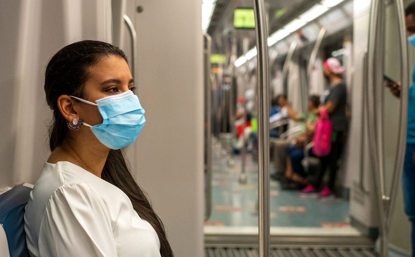 Woman wearing mask while using public transportation