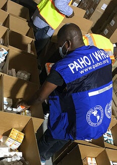 Warehouse personnel sorting items in boxes
