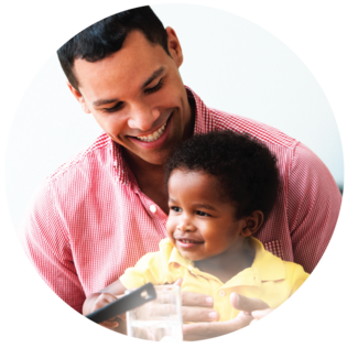 father and toddles smiling