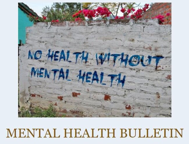 White brick wall with the sentence "No health without mental health"